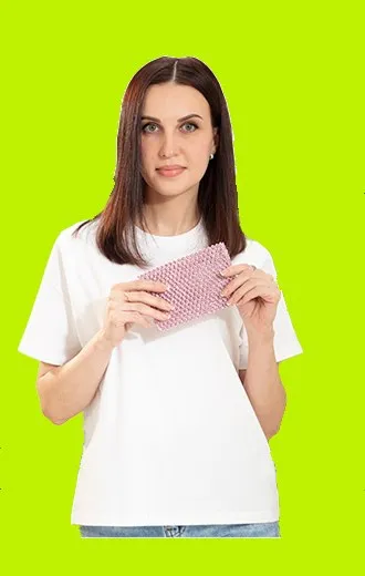 Woman holding a pink mesh scrubber